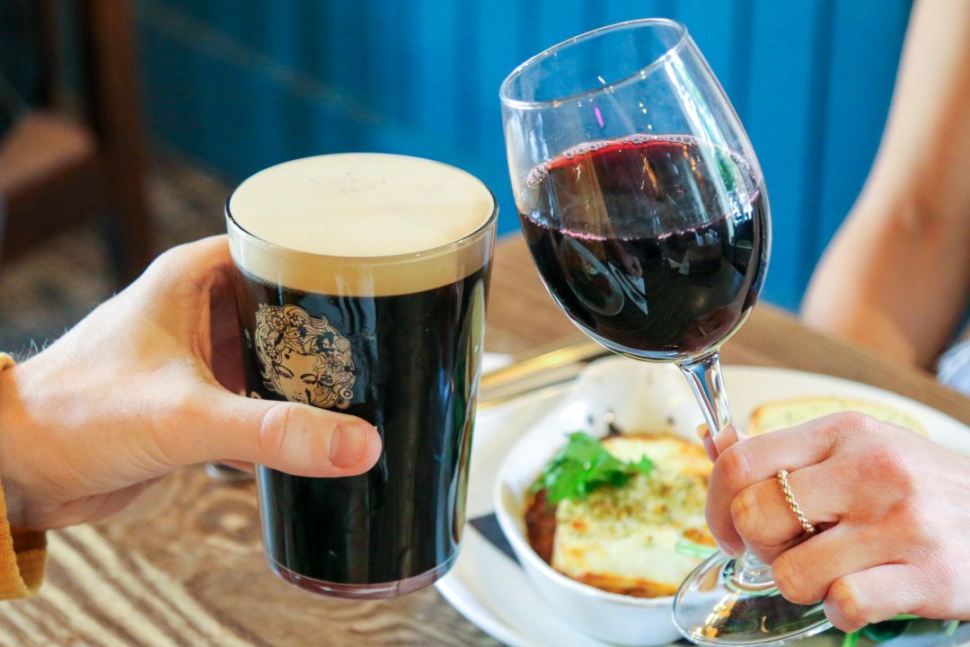 co-workers enjoying a pub lunch with a drink