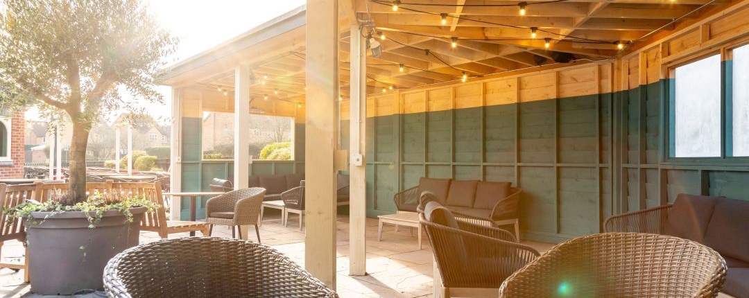 The Bear's pub garden in Rugby with fixed roofing catching the sunlight