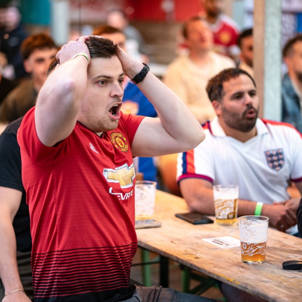 Sport fans watching premier league football at the pub