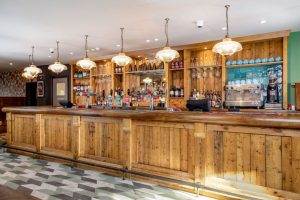 The bar at the bear pub rugby - wooden with suspended lights